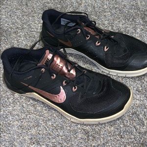 Black and rose gold Nike Metcon